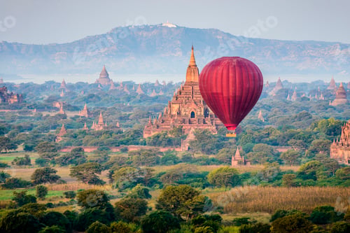 Preview: Hot air balloon flying over towers