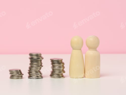 Preview: Stack of metal coins and wooden figures of men on a white table.