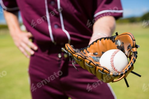 Preview: Mid section of baseball pitcher showing ball in glove