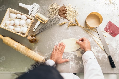 Preview: Baker kneading dough in a bakery.