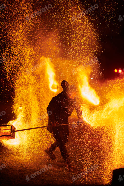 Preview: Silhouette of Two Fire Performers Creating Sparks Against Night field