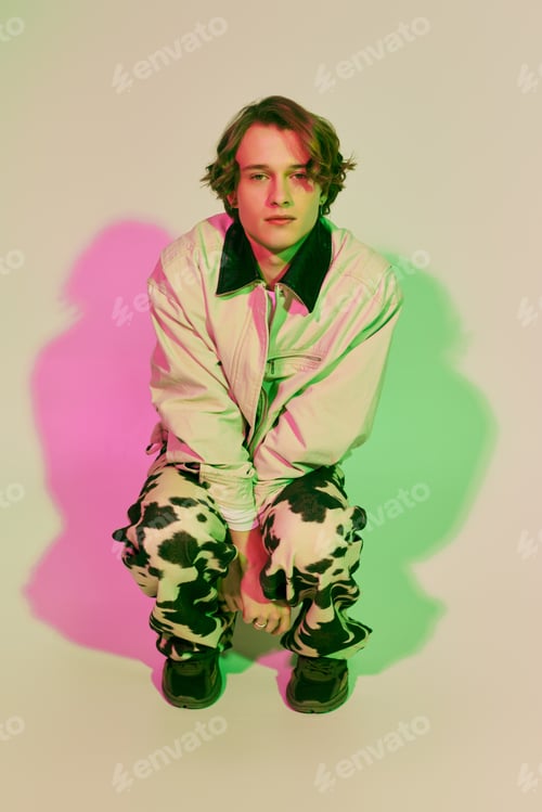 Preview: Fashionable young man showcases unique style in vibrant colors and striking poses