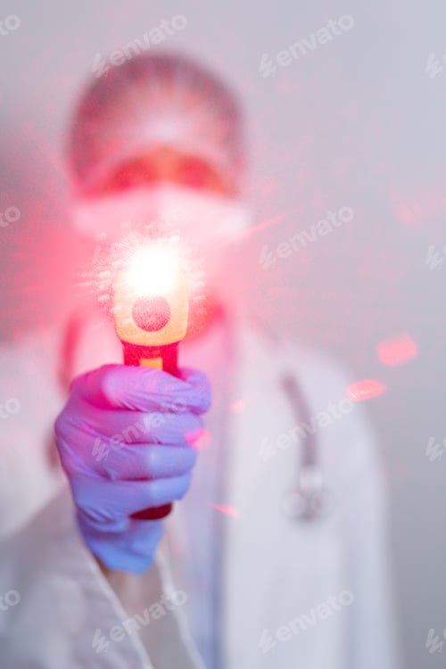 Preview: Healthcare worker holding gun thermometer and wearing coronavirus covid19 mask