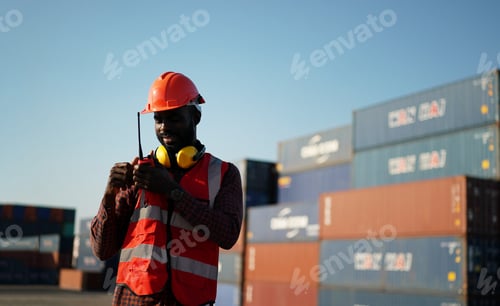 Preview: Foreman control loading Containers box from Cargo freight ship for import export.