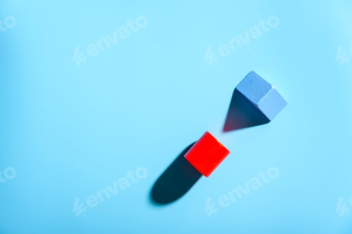 Preview: Two small pieces of wood isolated on plain blue background with hard shadows.