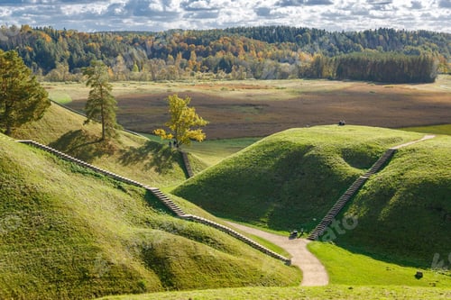 Preview: Seasonal view of historic Kernave in Lithuania with golden fields and a curving footpath
