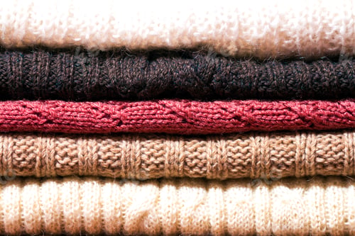 Preview: Stack of warm woolen cozy knitted sweaters