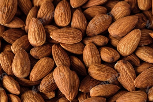 Preview: Almonds in wood bowl on wood table.Diet raw material