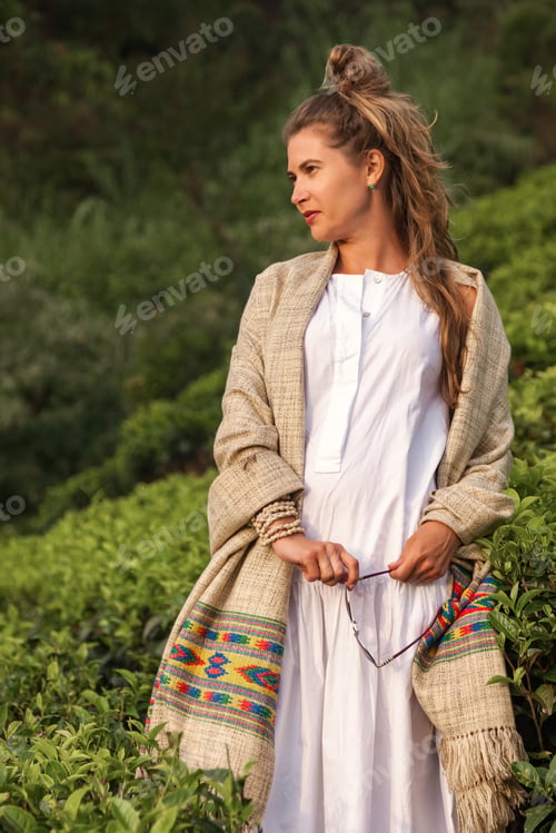 Preview: Woman Enjoying Tranquility on a Tea Plantation Surrounded by Lush Greenery During Golden Hour