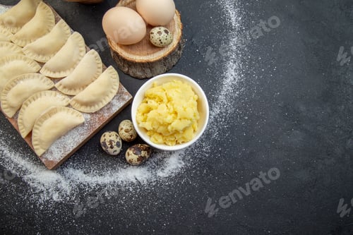 Preview: top view raw little hotcakes with flour mushed potatoes and eggs on dark background pie dough cake
