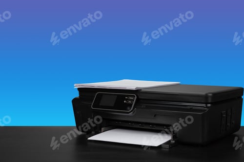 Preview: Compact laser printer on black desk against blue background
