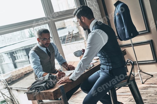 Preview: Men Discussing Design in Tailoring Business