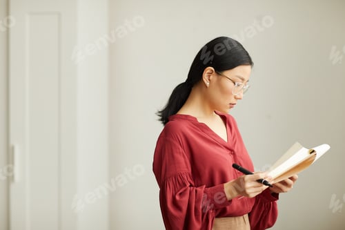 Preview: Successful Asian Businesswoman Reading Document