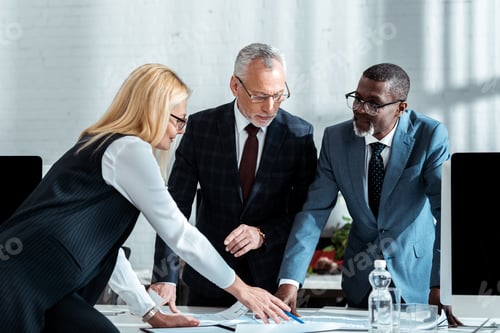 Preview: cropped view of african american businessman and businesswoman shaking hands in office