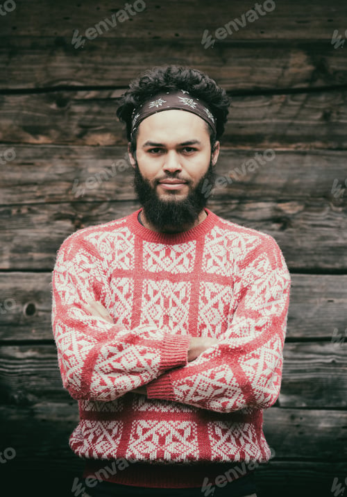 Preview: portrait of young hipster in front of wooden house