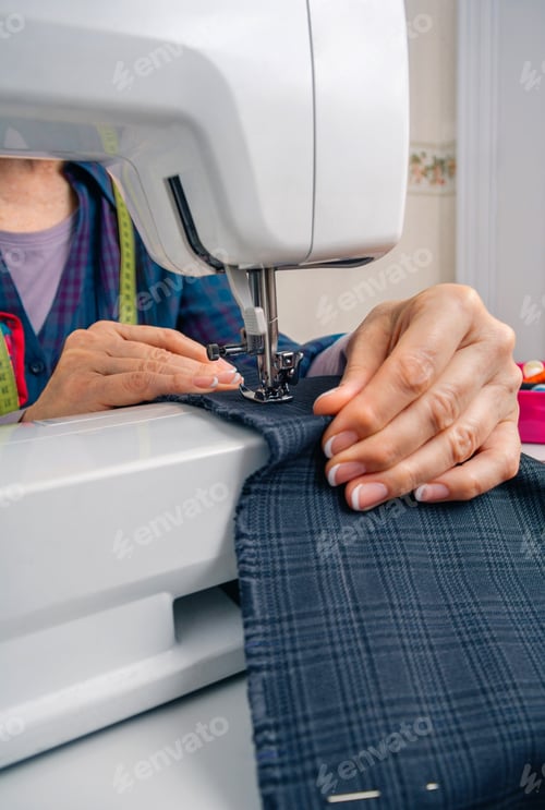 Preview: Seamstress hands working on a sewing machine