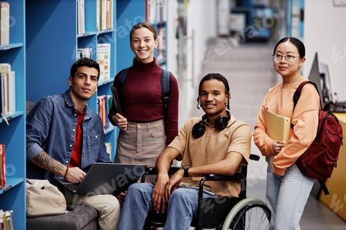 Preview: Diverse group of students with young man in wheelchair in college