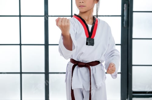 Preview: Close up shot of young taekwondo student shows different postures in front of white pattern