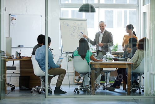 Preview: His team is all ears. Shot of a group of coworkers in a boardroom meeting.