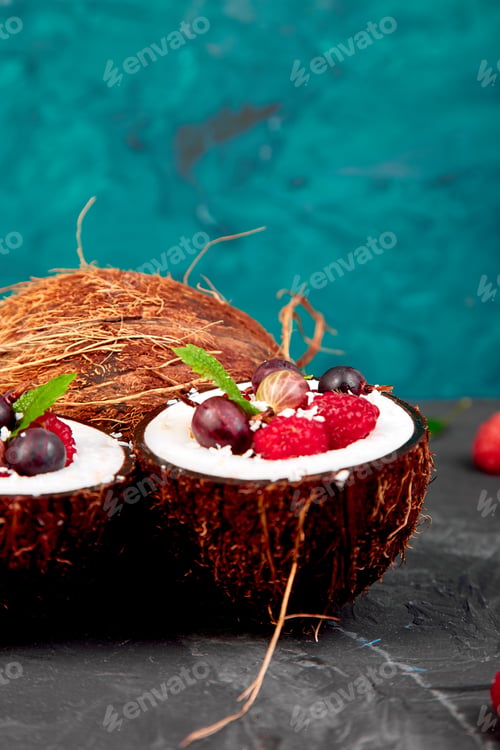 Preview: Fruit salad agrus, gooseberry, rasbberry in coconut shell bowl