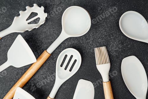 Preview: Ceramic kitchen utensils arranged neatly on a dark surface for culinary use