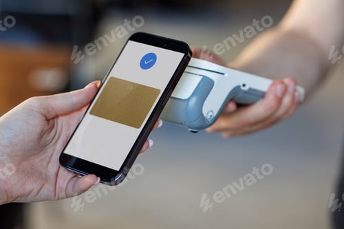 Preview: A customer uses a smartphone to make a contactless payment at a grocery store checkout