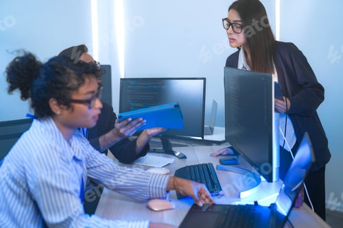 Preview: Diverse software developers in a lively discussion about a project.