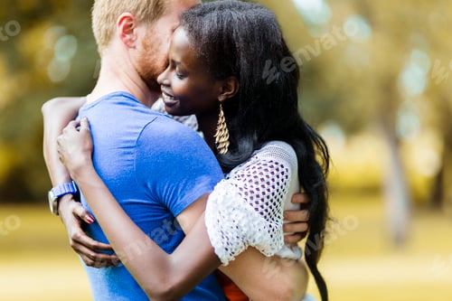 Preview: Couple in love hugging and kissing peacfully outdoors