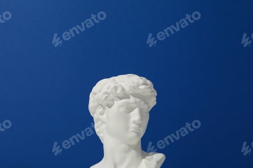 Preview: Ancient head on blue background, space for text