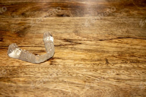 Preview: A Plastic Tooth Guard On A Wooden Table
