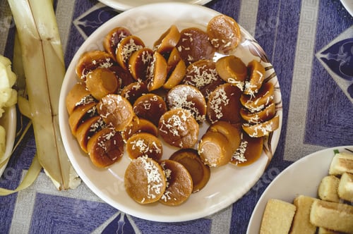 Preview: High angle shot of delicious Filipino Kutsinta treats in a white plate