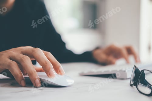 Preview: Closeup businessman using computer mouse with computer keyboard