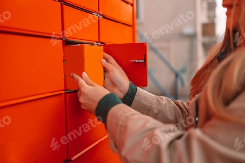 Preview: Woman picks up mail from automated self-service post terminal machine