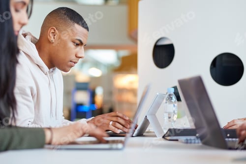 Preview: University students using laptops and digital tablet, working together