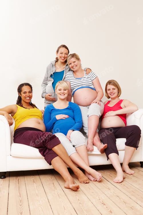 Preview: A group of multi-ethnic pregnant women sitting on a couch and smiling at the camera