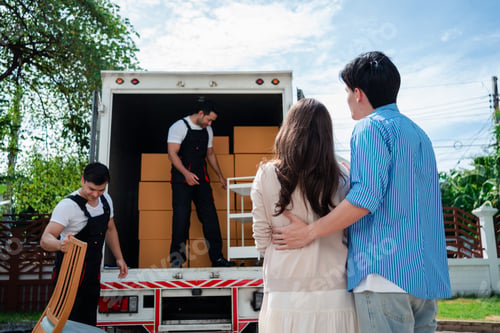 Preview: Asian Couple check while unloading boxes and furniture from a pickup truck