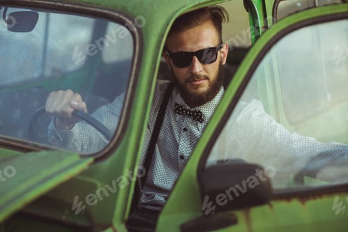 Preview: Young stylish handsome man, wearing shirt and sunglasses, drivin