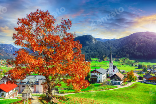 Preview: Alpine green fields and traditional wooden houses view of the Gosau village at autumn sunny day.
