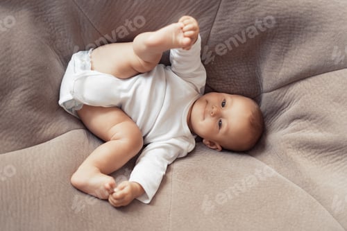 Preview: Infant Lying on a Beanbag Wearing White Onesie