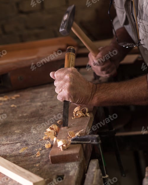 Preview: Experienced senior carpenter working in his vintage workshop.
