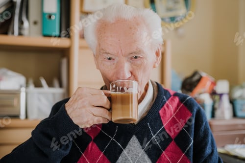 Preview: Portrait of happy senior drinking coffee