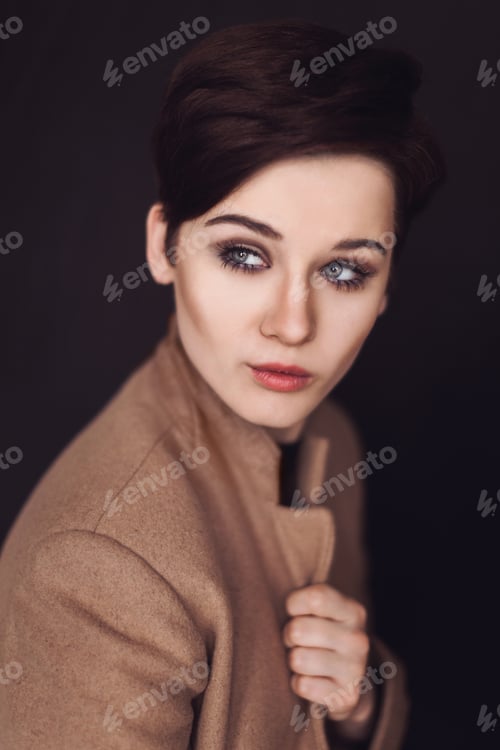 Preview: Close-up portrait of fashionable young blueeyed woman with makeup in coat