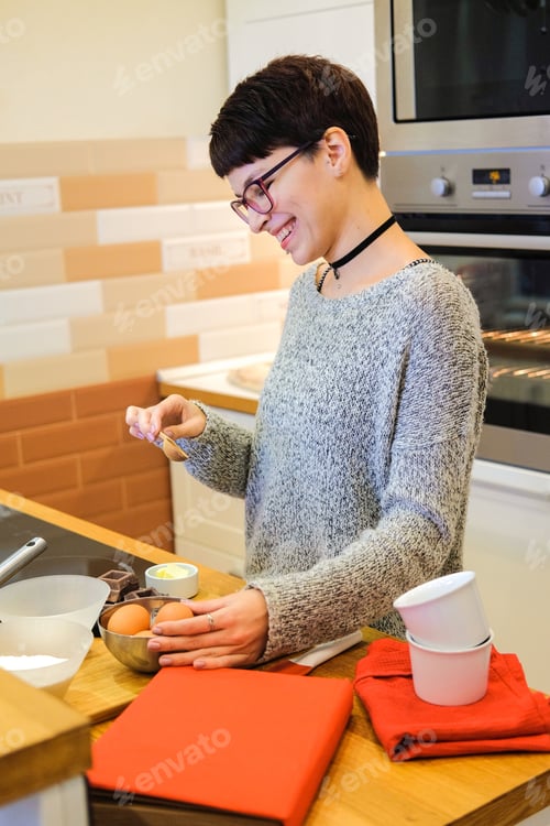 Preview: Short-Haired Woman To Cook Chocolate Fondant Recipe From Cookery Books. The Girl Preparing For Cook