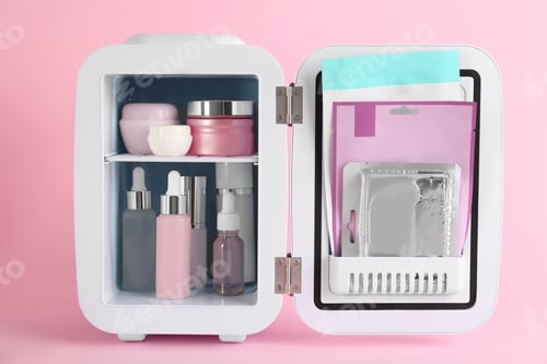 Preview: Open cosmetic refrigerator with skin care products on pink background