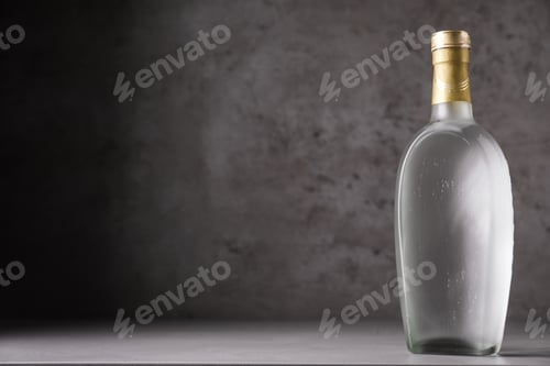 Preview: Bottle of vodka on table against grey background. Space for text