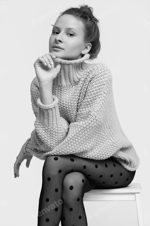 Preview: Studio Portrait Of Cheerful Fashion Hipster Girl In Cozy Sweater And Black Tights Isolated On White
