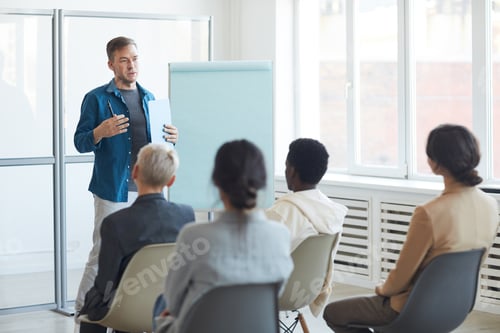 Preview: Mature Man Giving Presentation to Audience