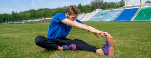 Preview: sportsman doing stretching exercise on the stadium before summer practices