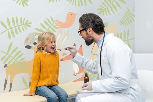 Preview: young male pediatrist giving mixture to smiling little girl