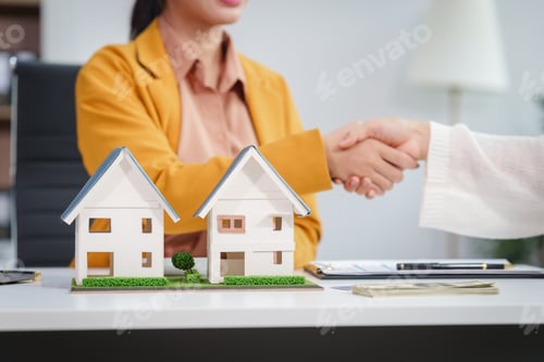 Preview: Asian businesswoman discusses home purchase contracts with clients at her desk, focusing on loans